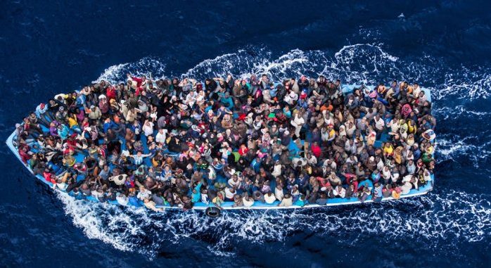 4/Hundreds of refugees and migrants aboard a fishing boat are pictured moments before being rescued by the Italian Navy as part of their Mare Nostrum operation in June 2014. Among recent and highly visible consequences of conflicts around the world, and the suffering they have caused, has been a dramatic growth in the number of refugees seeking safety by undertaking dangerous sea journeys, including on the Mediterranean.  The Italian Coastguard / Massimo Sestini